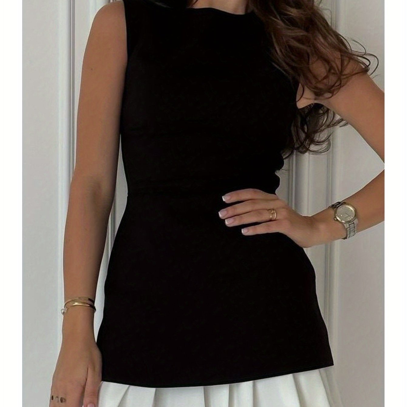 Fashion- forward Black Sleeveless Dress with a Trendy White Pleated Skirt Attachment